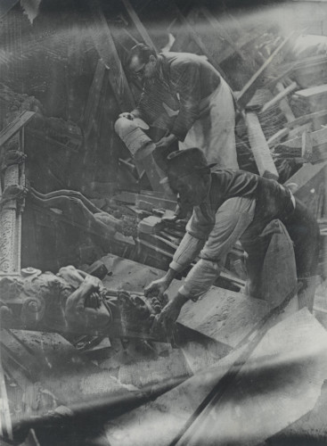 Photograph of workmen salvaging pieces of the screen in Middle Temple Hall, 16 October 1940 (MT/19/PHO/4/3/1)